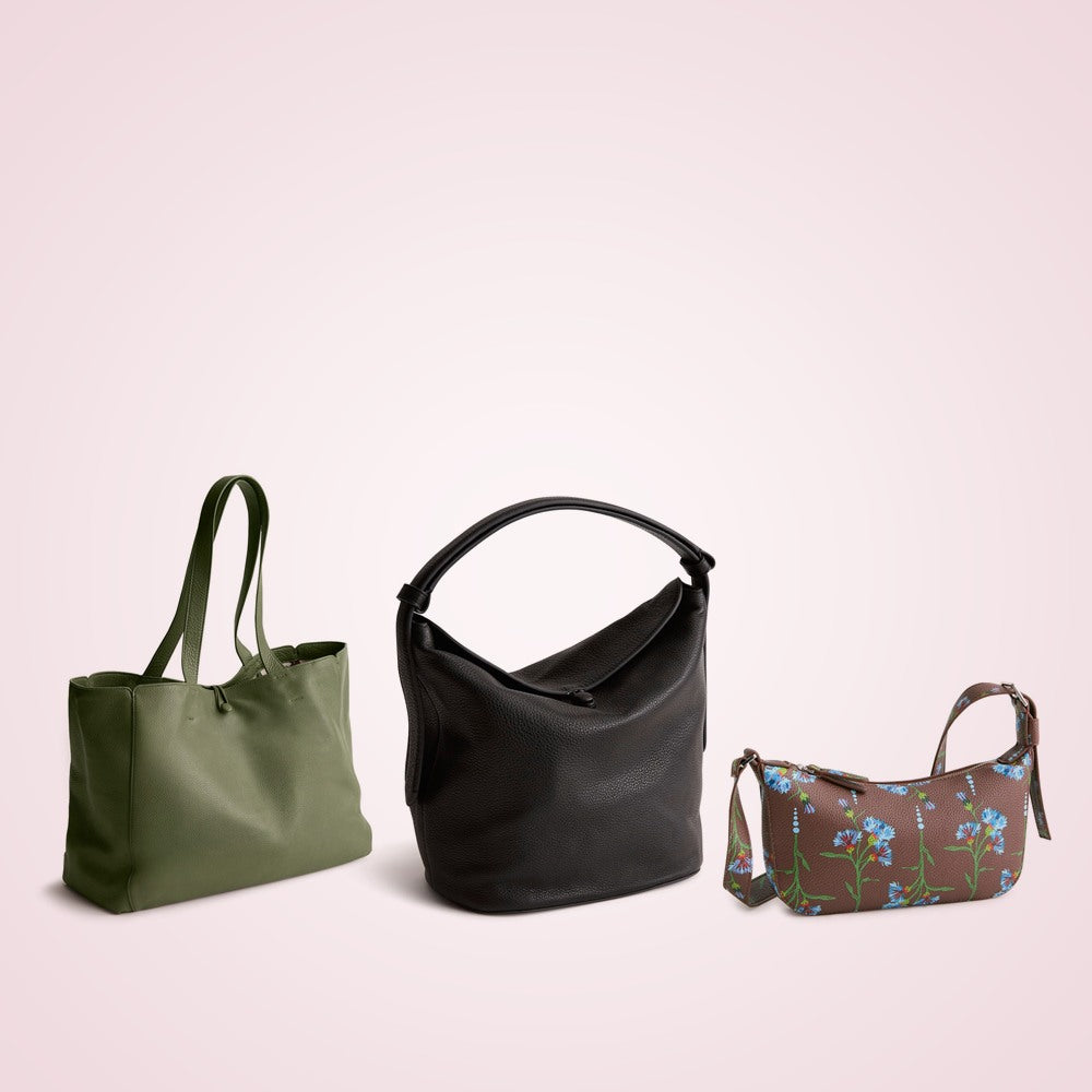 Olive green tote, black bucket shoulder bag and brown floral crossbody bag on a soft rose background
