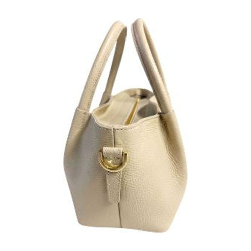 Beige pebbled top handle handbag side view with gold-tone D-ring